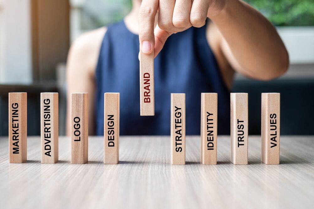 businesswoman-hand-placing-wooden-dominoes-with-te-2022-11-07-22-00-26-utc-1